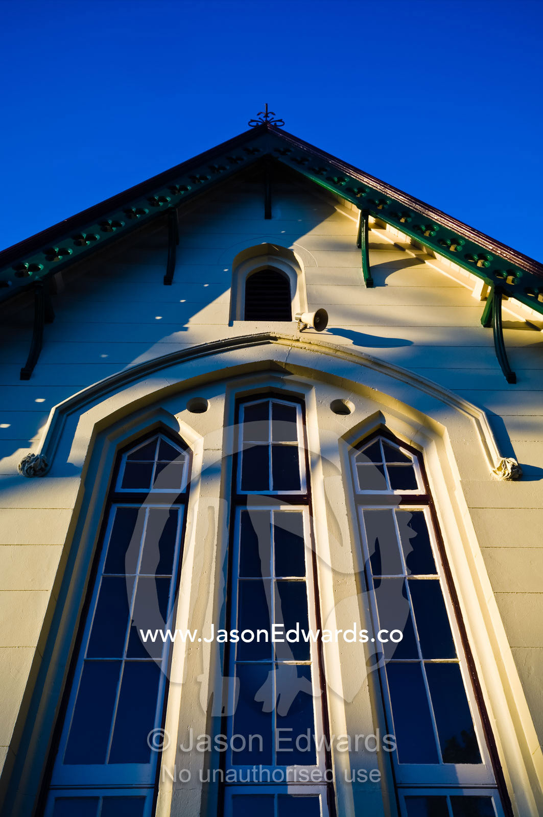 The ornate facade and window panes of a Victorian elementary school. Carlton North, Victoria, Australia