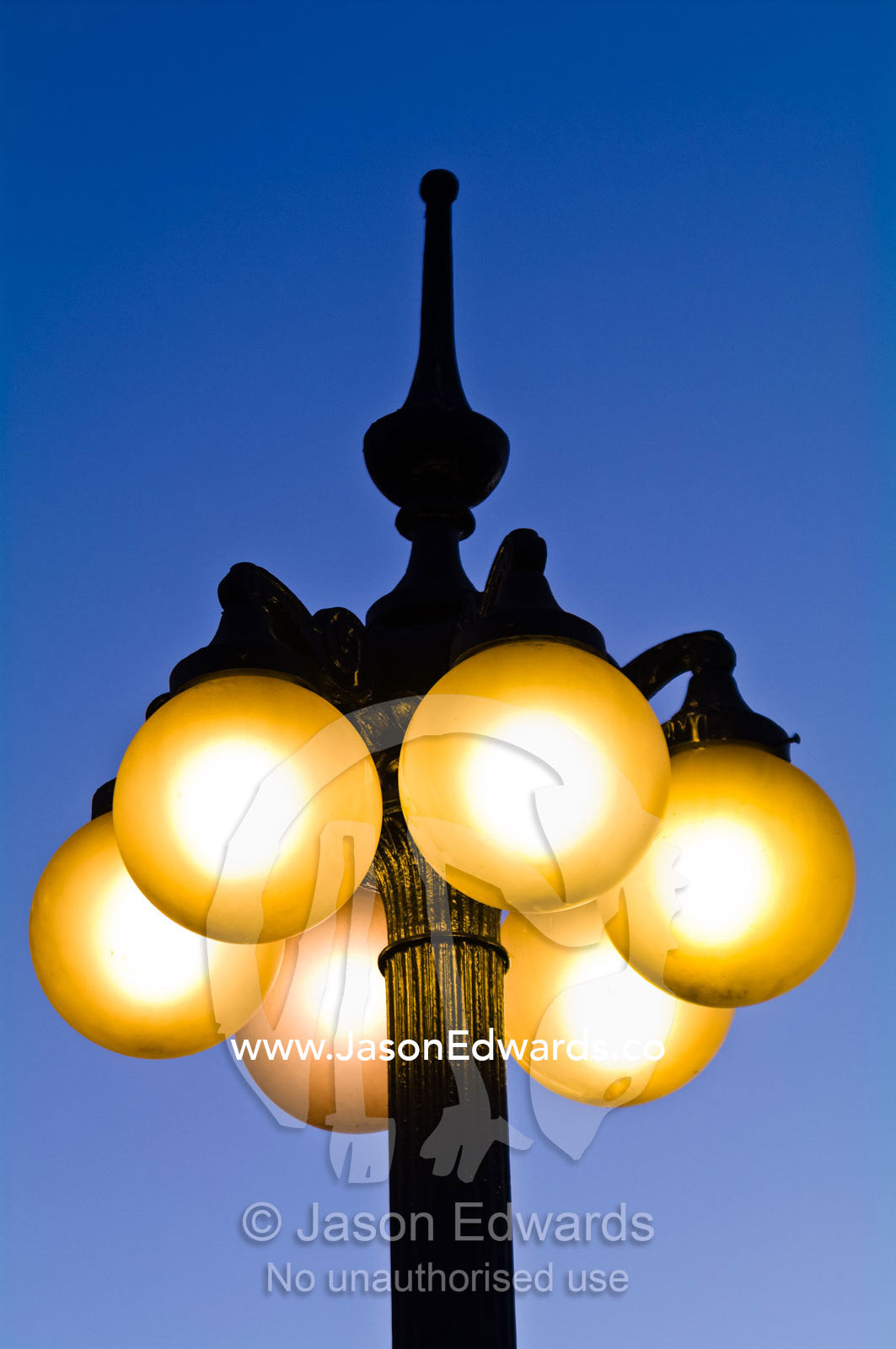 Antique spherical lights attached to ornate steel poles at sunset. Plaza Italia, Providencia District, Santiago, Chile
