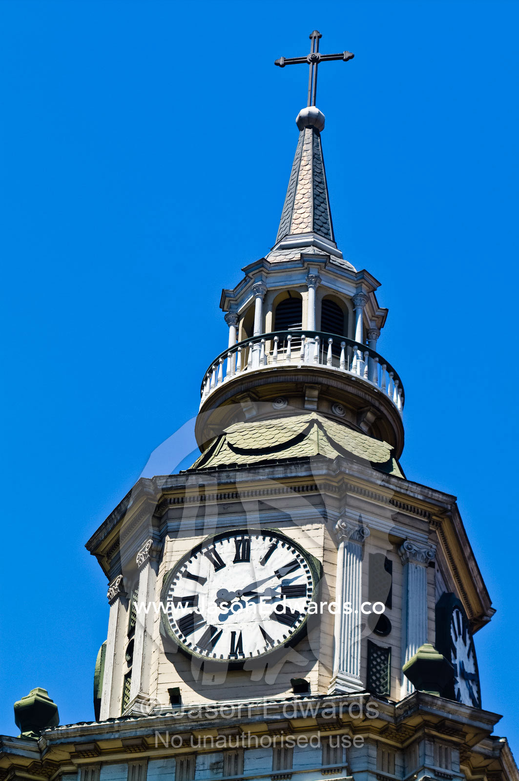 A clock face rests atop an ancient Christian church steeple. Iglesia San Francisco, Santiago, Chile