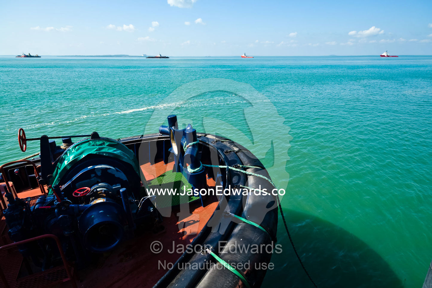 The large rubber fenders and winch of a tug boat moored at a marina. Darwin Waterfront, Darwin, Northern Territory, Australia