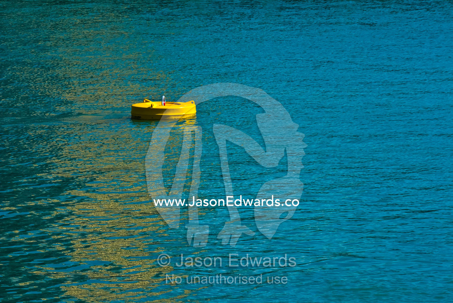 A bright yellow floating mooring buoy provides anchor in a marina. Darwin Waterfront, Darwin, Northern Territory, Australia
