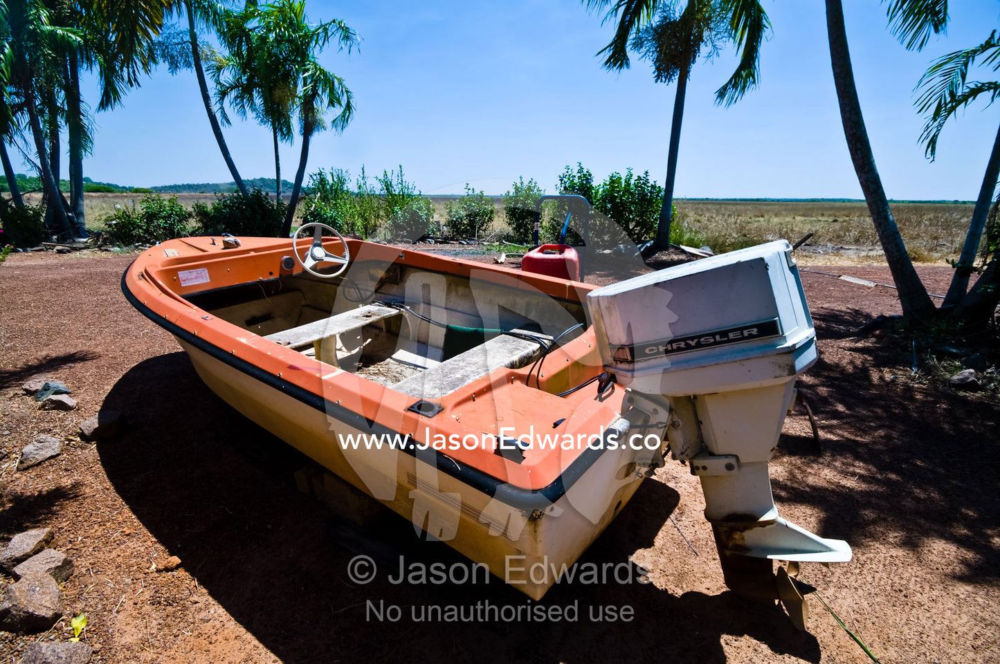 A faded old, weathered and beaten motor boat resting on dry land. Alligator River, Northern Territory, Australia