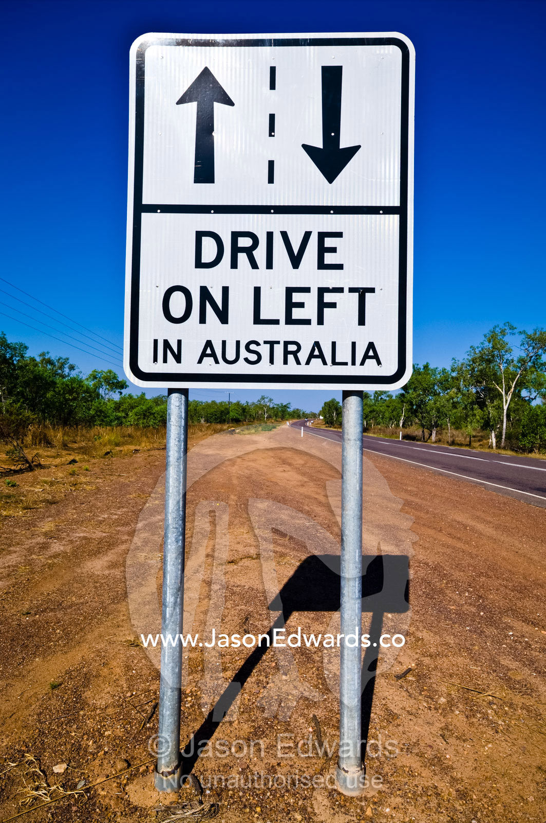 A sign advises tourists which side of the road is correct to drive on. Kakadu Highway, Northern Territory, Australia
