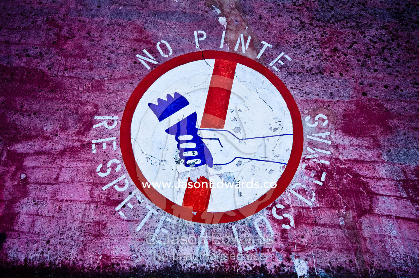 A sign in Spanish on a brick walls bans graffiti painting. near the Riachuelo River, La Boca, Buenos Aires, Argentina.