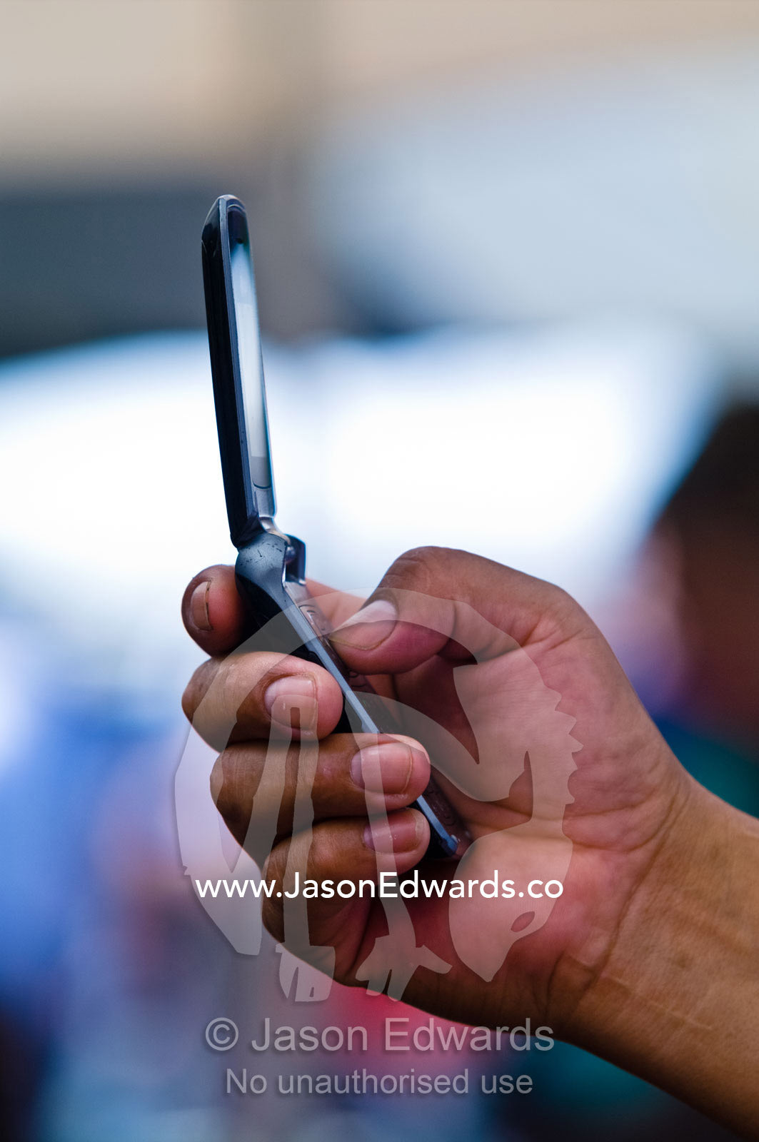 A person holds a mobile phone camera to capture a photograph and text. El Caminito, La Boca, Buenos Aires, Argentina.