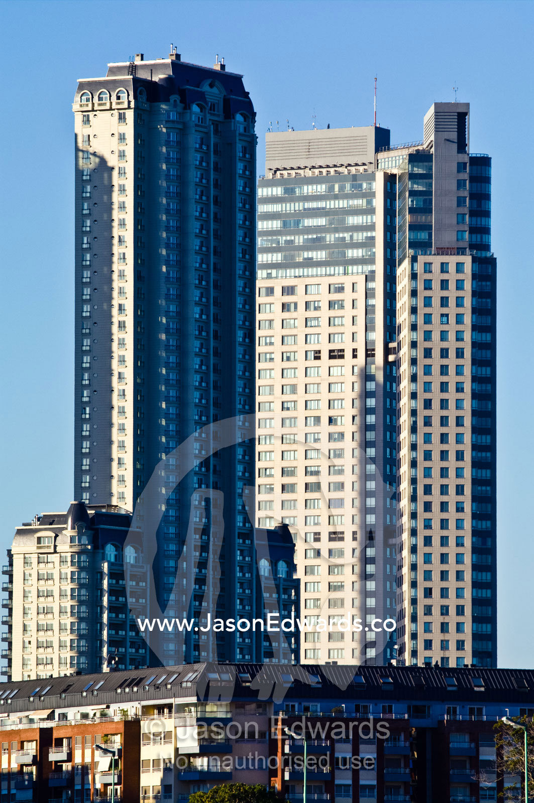 Modern highrise apartment towers rise into a clear blue sky. Puerto Madero, Buenos Aires, Argentina.