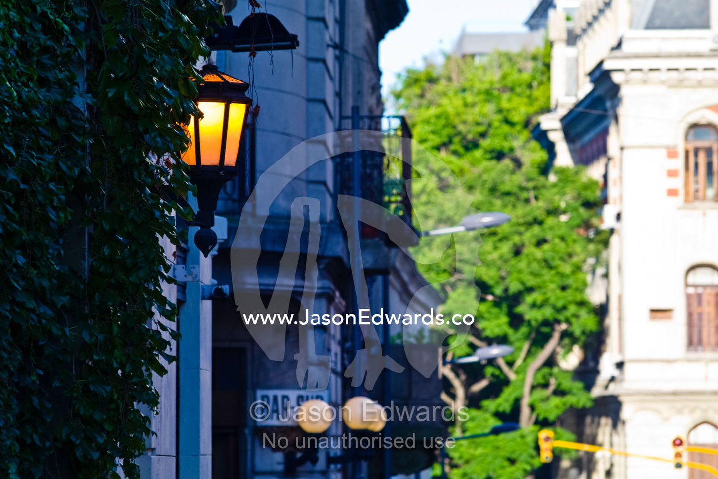 Antique lamps illuminate a street lined with bars and cafes. San Telmo, Buenos Aires, Argentina.
