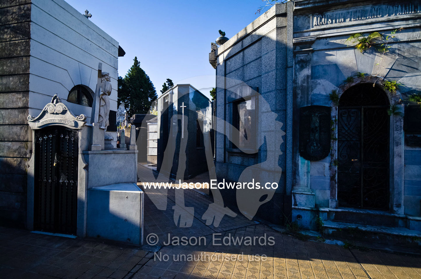 Tiles pave the alleyways between family mausoleums in a city cemetery. La Recoleta Cemetery, Recoleta, Buenos Aires, Argentina.