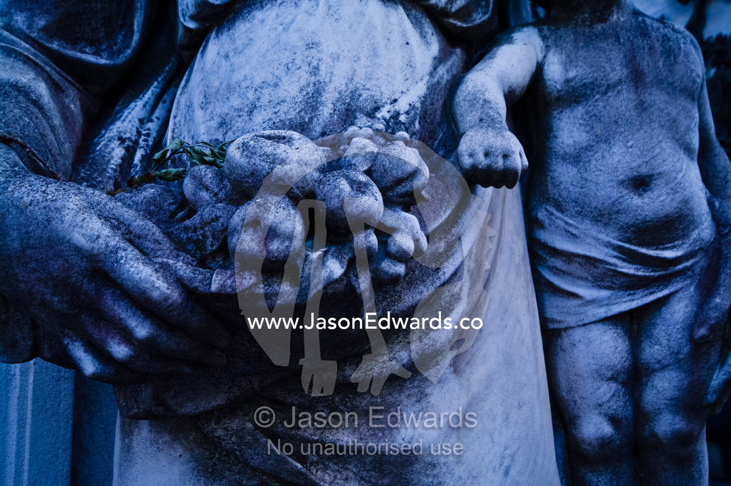 A statue of the Virgin Mary and Jesus Christ at a family mausoleum. La Recoleta Cemetery, Recoleta, Buenos Aires, Argentina.