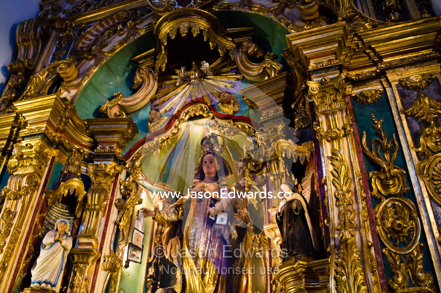 An ornate gold embossed statue of the Virgin Mary and baby Jesus. Our Lady of Pilar Basilica, Recoleta, Buenos Aires, Argentina.