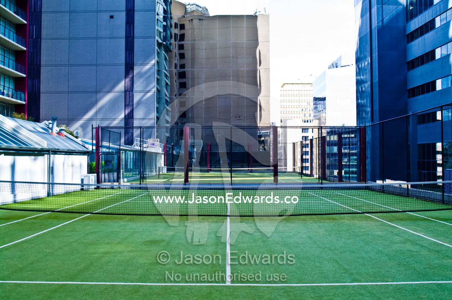 Buildings surround a tennis court in an inner city apartment complex. St Kilda Road, Melbourne, Victoria, Australia.