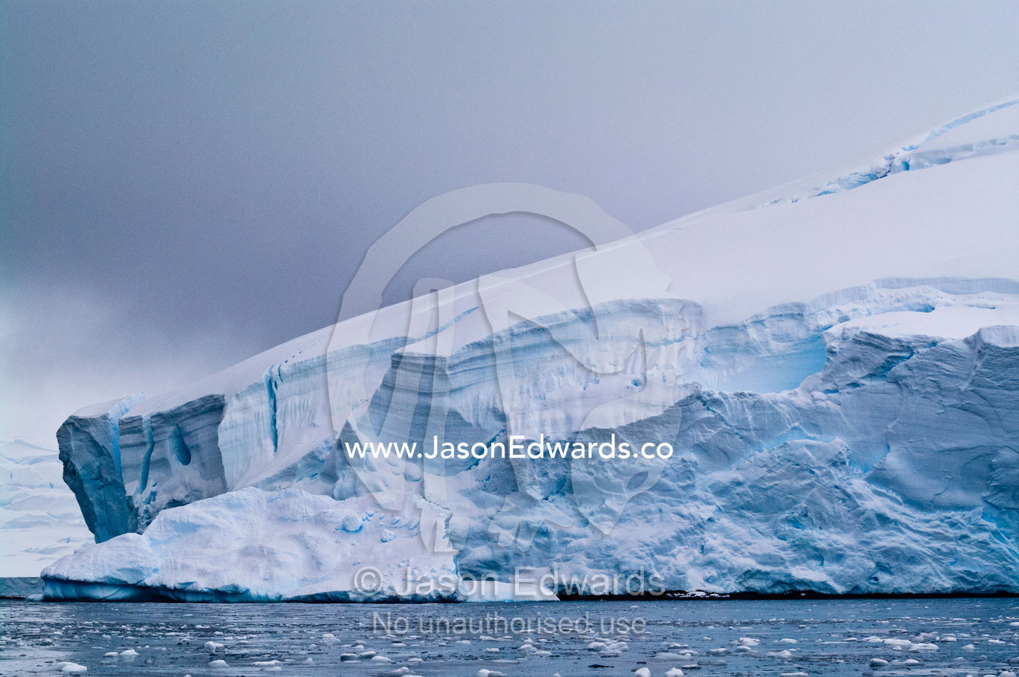 The massive protruding tongue of a glacier stretches into the ocean. Crystal Sound, Hanusse Bay, Antarctic Peninsula, Antarctic Circle, Antarctica.