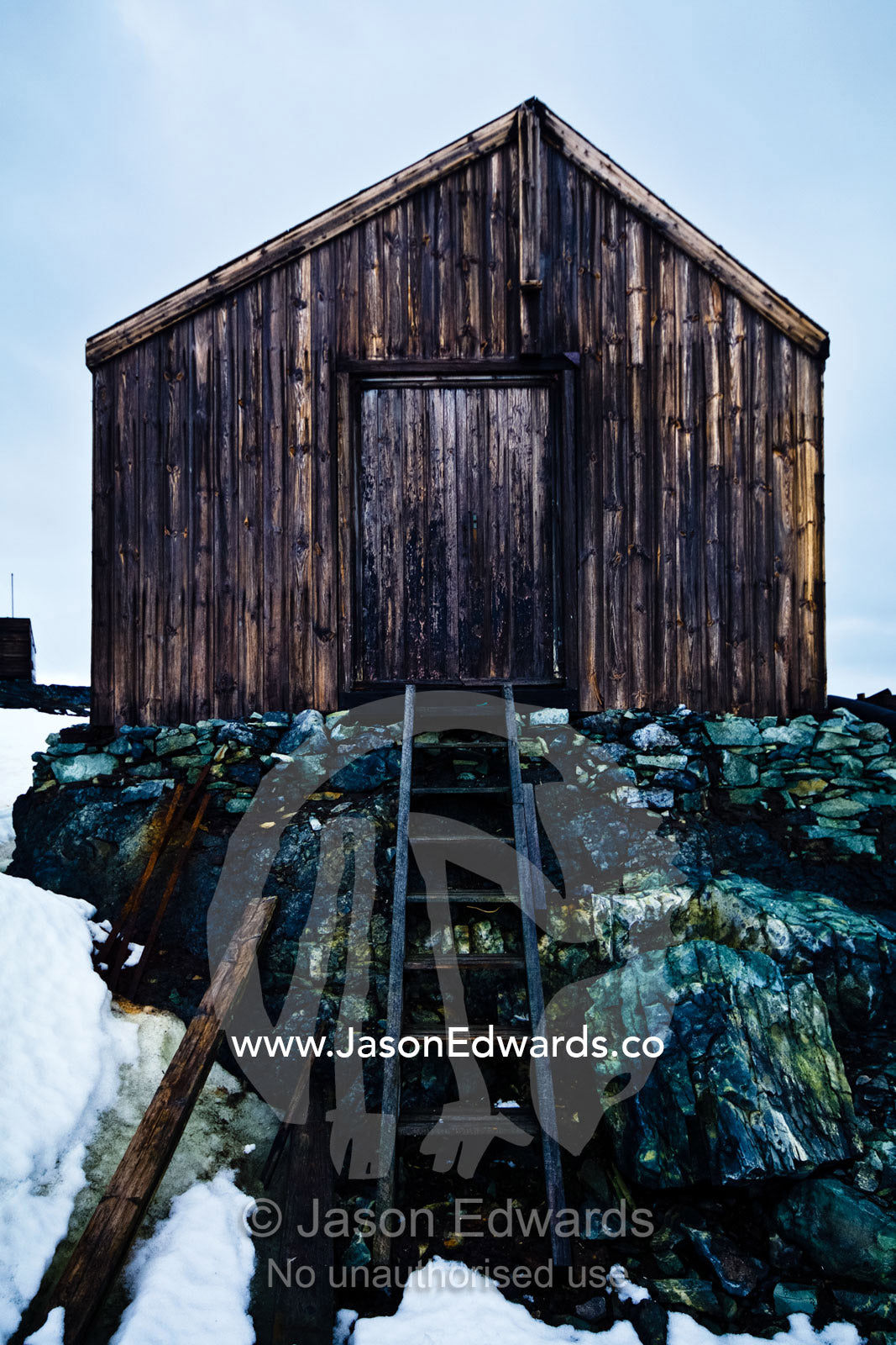 Weathered ruins of an abandoned Antarctic scientific research station. Station W, Detaille Island, Antarctic Peninsula, Antarctic Circle, Antarctica.