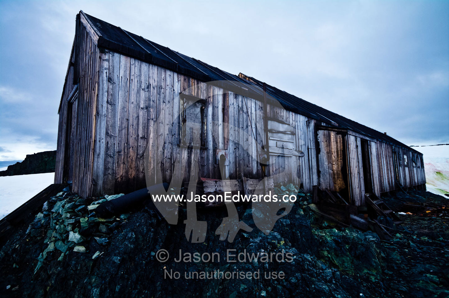 Weathered ruins of an abandoned Antarctic scientific research station. Station W, Detaille Island, Antarctic Peninsula, Antarctic Circle, Antarctica.