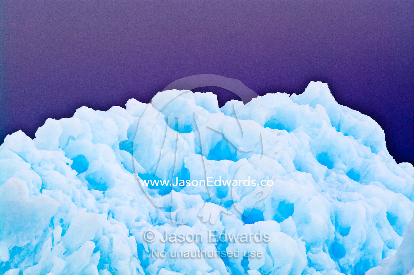 Razor serrations and erosion on the edge of an iridescent blue iceberg Fish Islands, Flouder Island, The Minnows, Crystal Sound, Antarctic Peninsula, Antarctic Circle, Antarctica.