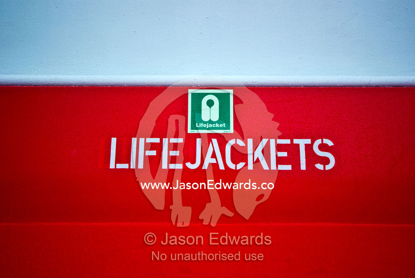 A bright red seat holds emergency life jackets on an ecotourism ship. Gerlache Strait, Graham Land, Antarctic Peninsula, Antarctica.