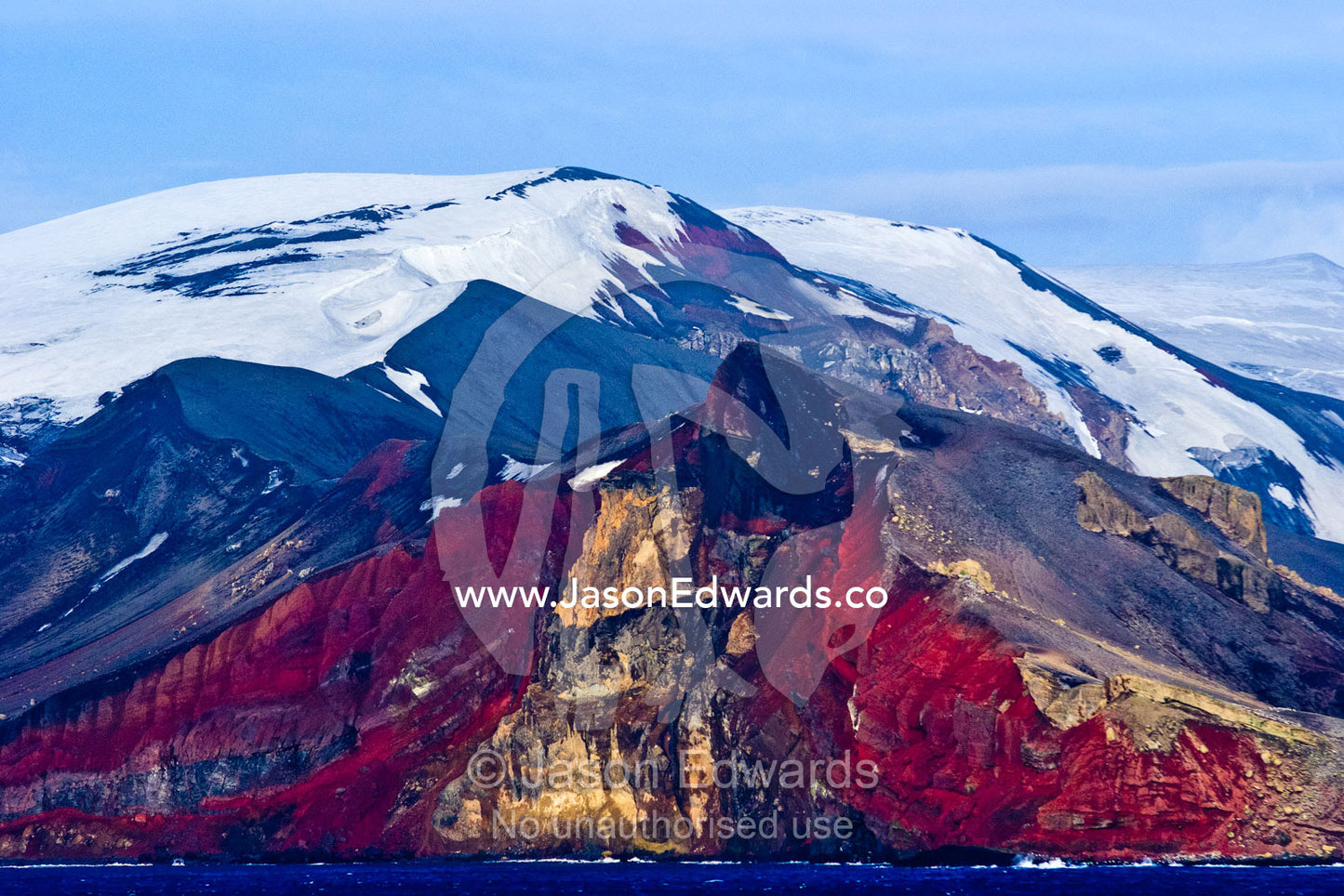 Rugged snow and ice encrusted mountain surrounding a volcanic caldera. Bransfield Strait, Deception Island, South Shetland Islands, Antarctic Peninsula, Antarctica.
