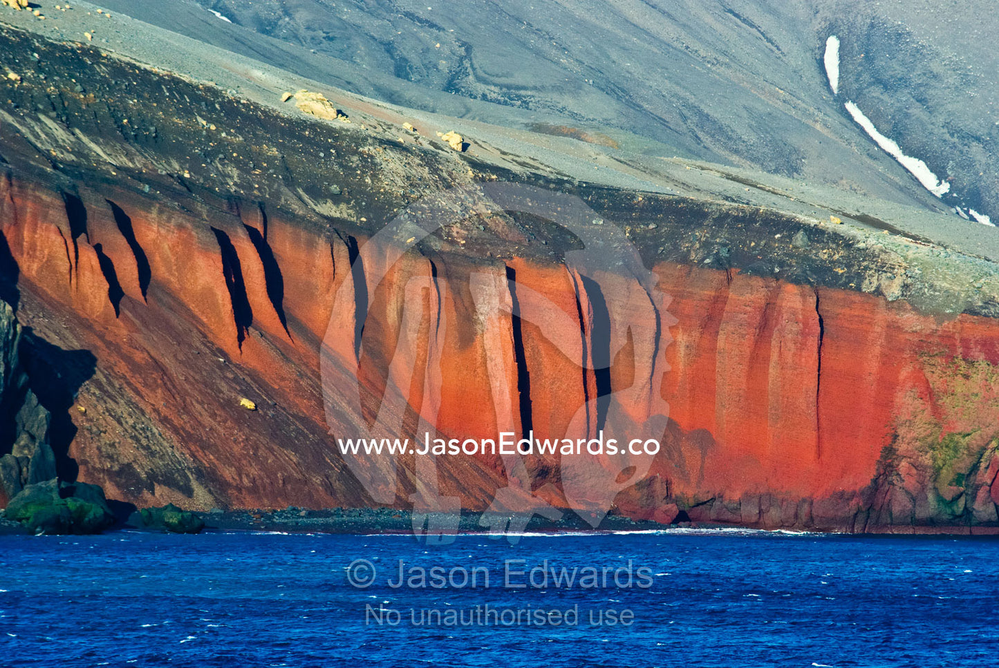 A rugged cliff face and escarpment surrounding a volcanic caldera. Bransfield Strait, Deception Island, South Shetland Islands, Antarctic Peninsula, Antarctica.