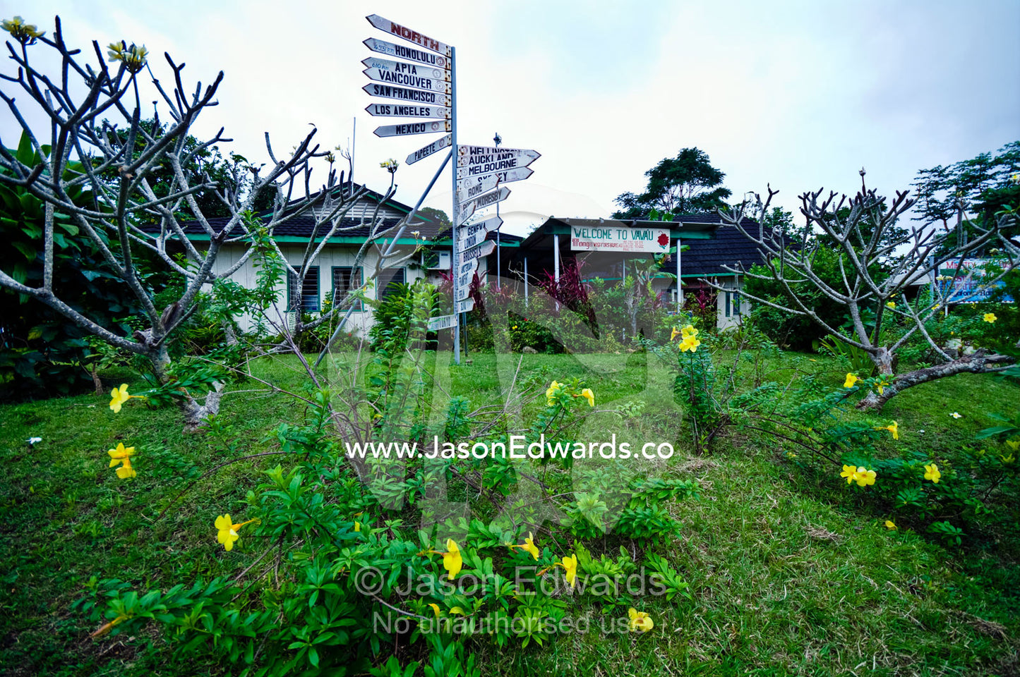 Tourist visitor centre and city directional sign post in garden. Port of Refuge, Neiafu, Vava'u Island Group, Pacific Ocean, Oceania, Kingdom of Tonga.