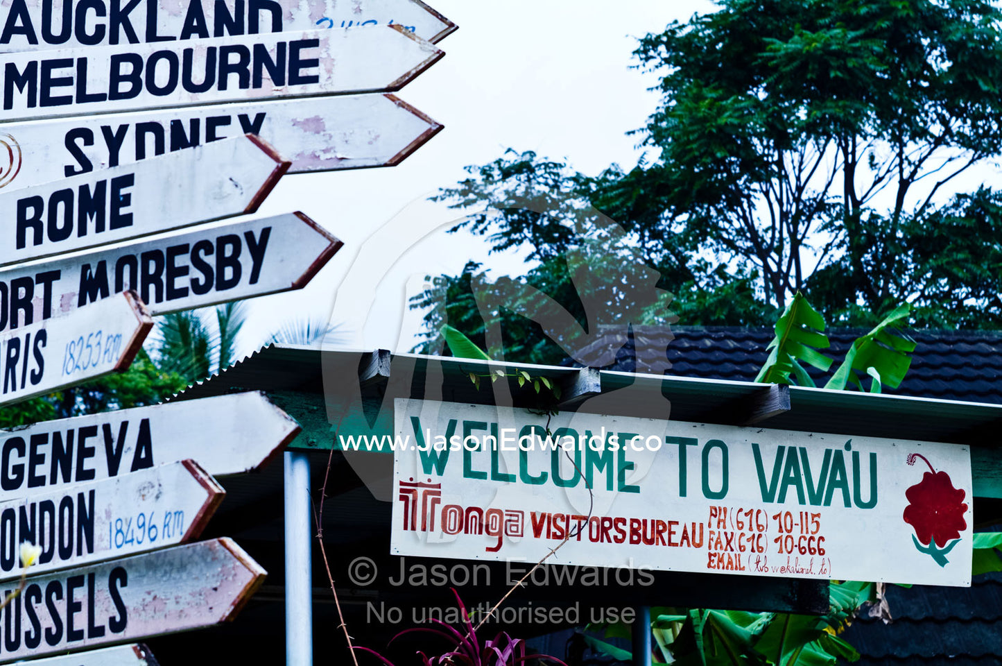 Tourist visitor centre and city directional sign post in garden. Port of Refuge, Neiafu, Vava'u Island Group, Pacific Ocean, Oceania, Kingdom of Tonga.