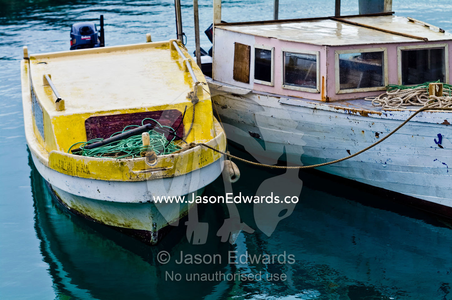 A pair of weathered timber fishing boats moored in a safe harbour. Port of Refuge, Neiafu, Vava'u Island Group, Pacific Ocean, Oceania, Kingdom of Tonga.