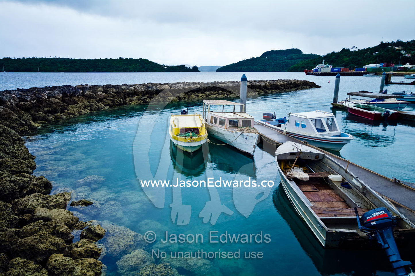 Weathered fishing boats and an aluminium punt moor in a safe harbour. Port of Refuge, Neiafu, Vava'u Island Group, Pacific Ocean, Oceania, Kingdom of Tonga.