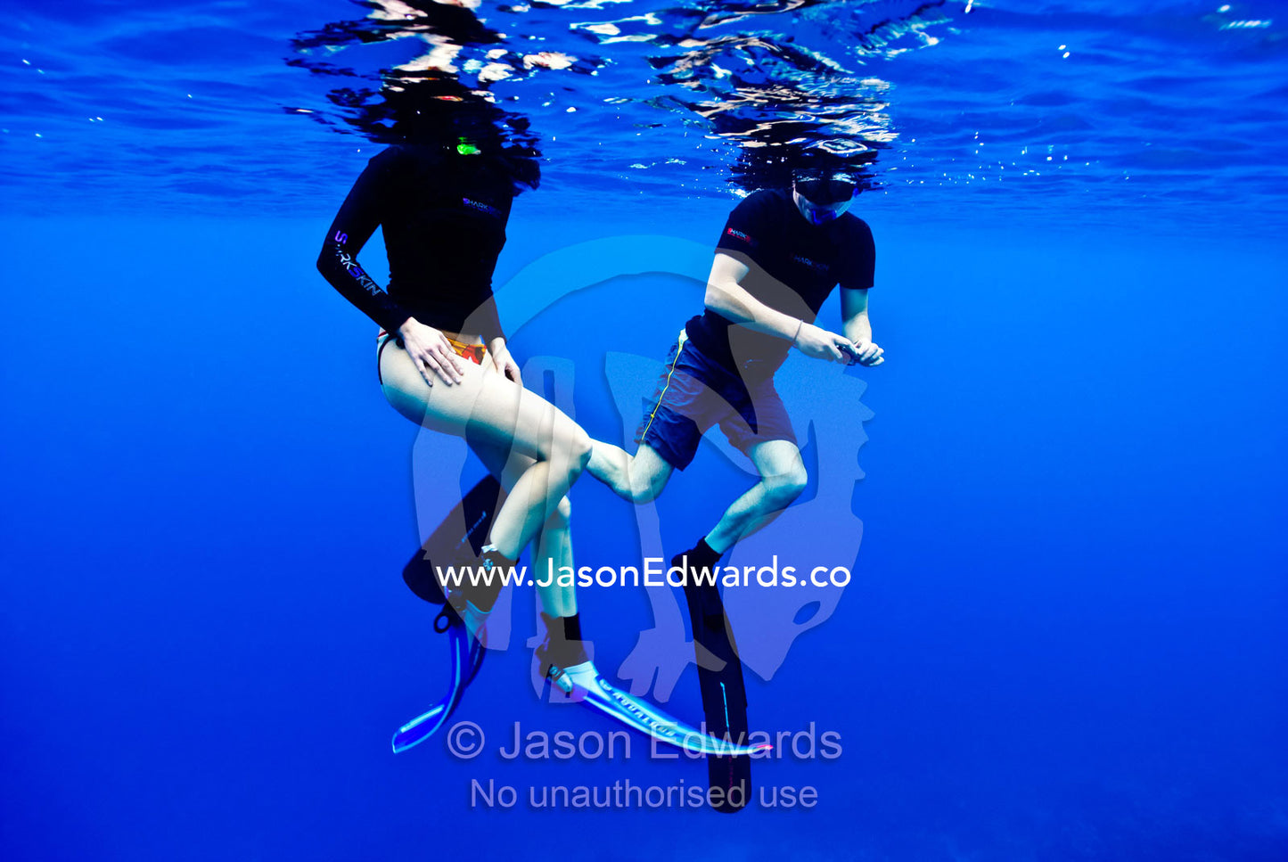 A couple float and breathe on the ocean surface whilst snorkelling. Vava'u Island Group, Pacific Ocean, Oceania, Kingdom of Tonga.