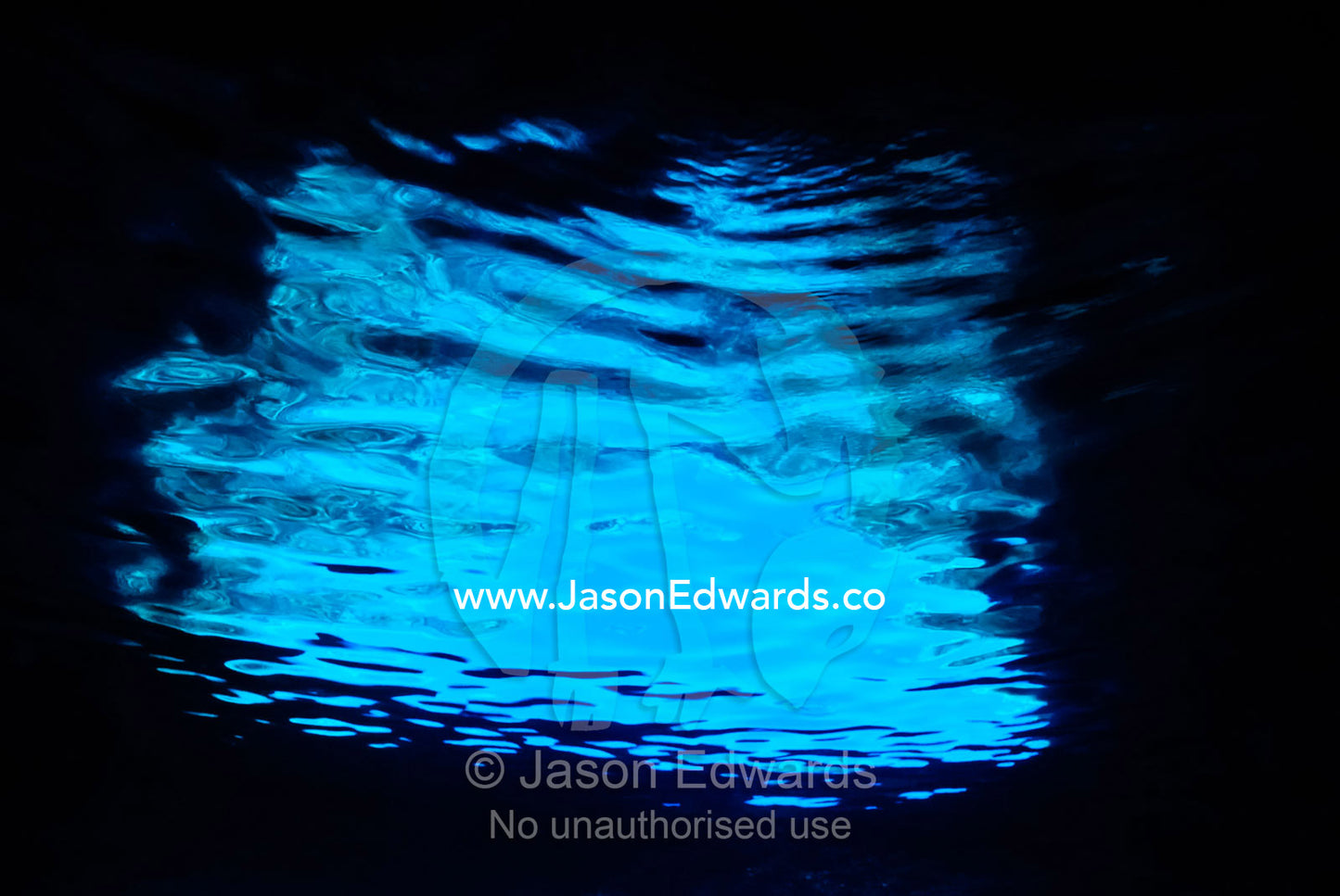 Sunlight reflecting off the surface of the water in a limestone cave. Mariner's Cave. Vava'u Island Group, Pacific Ocean, Oceania, Kingdom of Tonga.