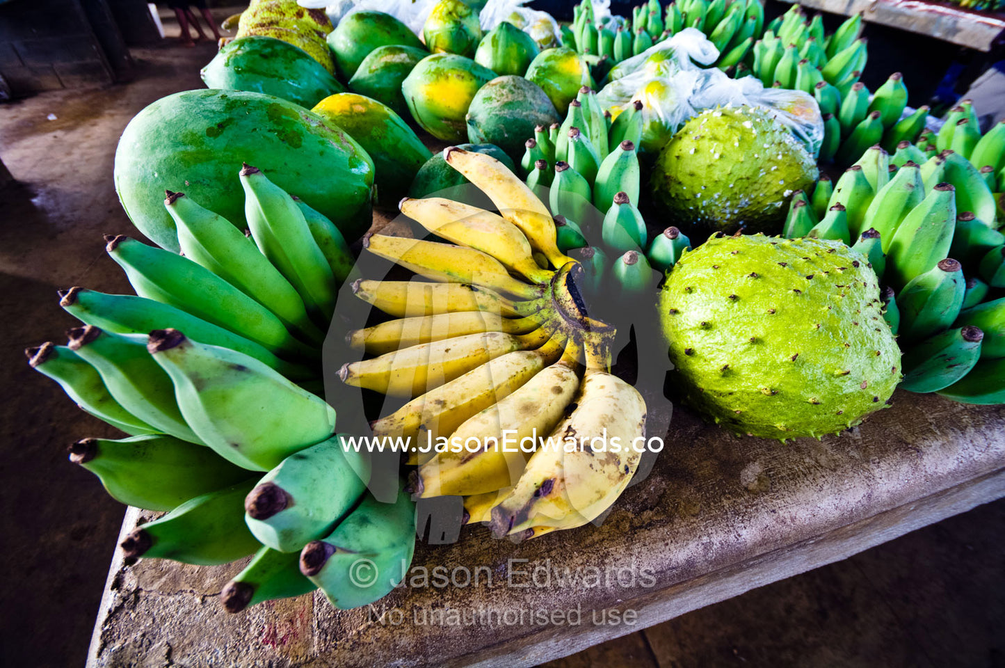 Ripe and unripe green bananas, papaya and breadfruit in a market. Utukalongalu Market, Port of Refuge, Neiafu, Vava'u Island Group, Pacific Ocean, Oceania, Kingdom of Tonga.