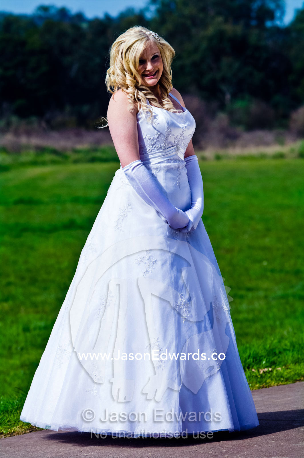 A teenage girl prepares to attend her debutante ball in a white dress. Melbourne, Victoria, Australia.