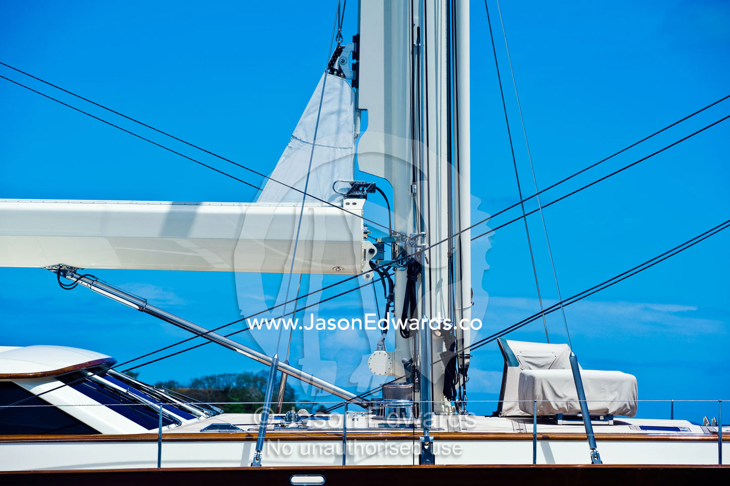 The cockpit bridge, main mast and sail rigging on a luxury yacht. Momi Bay, Viti Levu, Malolo Archipelago, Pacific Ocean, Fiji Islands.