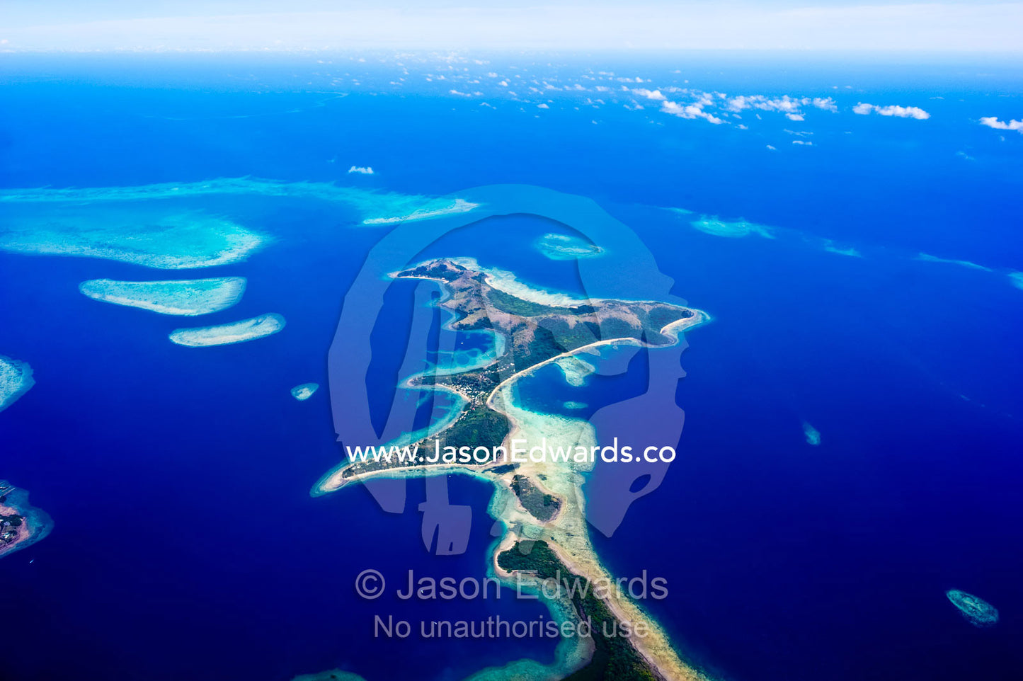 A sand spit island surrounded by coral reefs and a vast blue ocean. Taveuni Island, Somosomo Strait, Pacific Ocean, Fiji Islands.