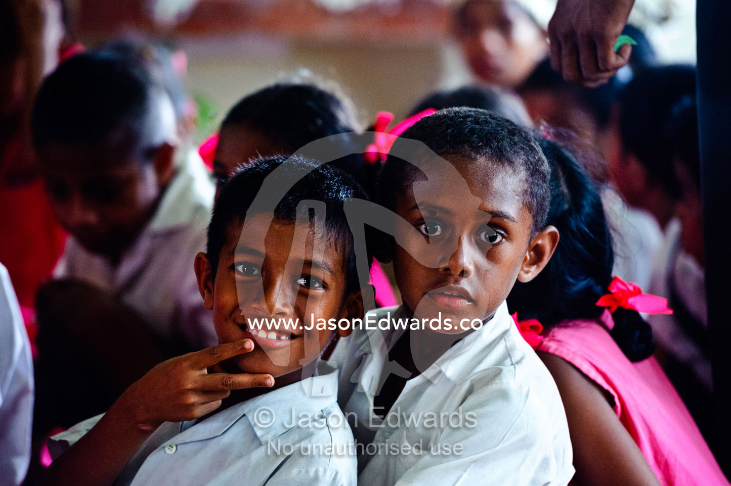 Micronesian boys watch a dance performance by school students. Tabiang Village, Rabi Island, Somosomo Strait, Pacific Ocean, Fiji Islands.