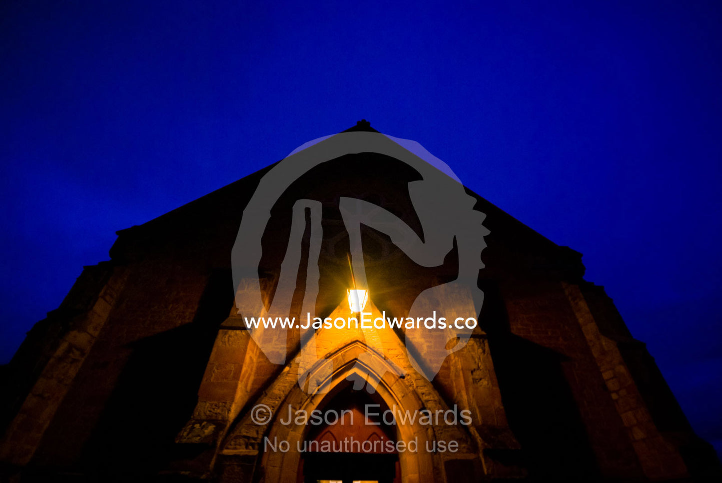 The facade of a church rises into the night sky on Christmas Eve. Christs Church, Castlemaine, Victoria, Australia.