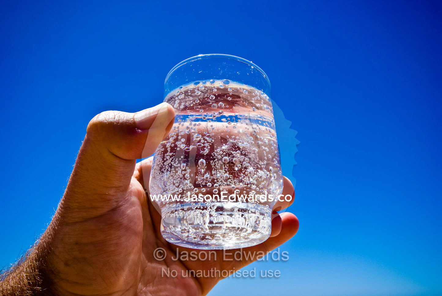 A cool, refreshing glass of sparkling mineral water on a summers day. Rye Beach, Melbourne, Victoria, Australia.
