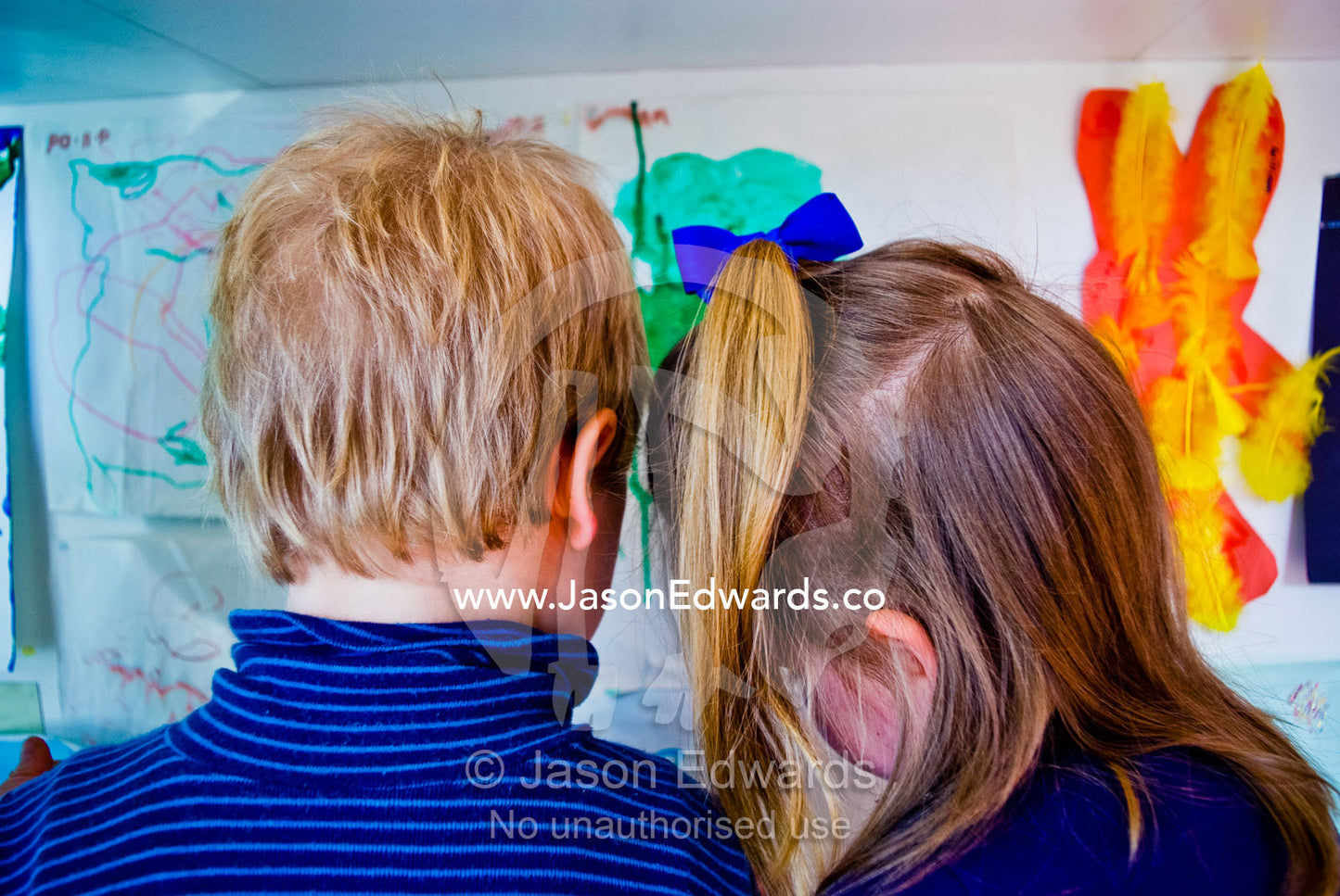 Two young friends work together in a kitchen to bake gingerbread. Carlton North, Melbourne, Victoria, Australia.