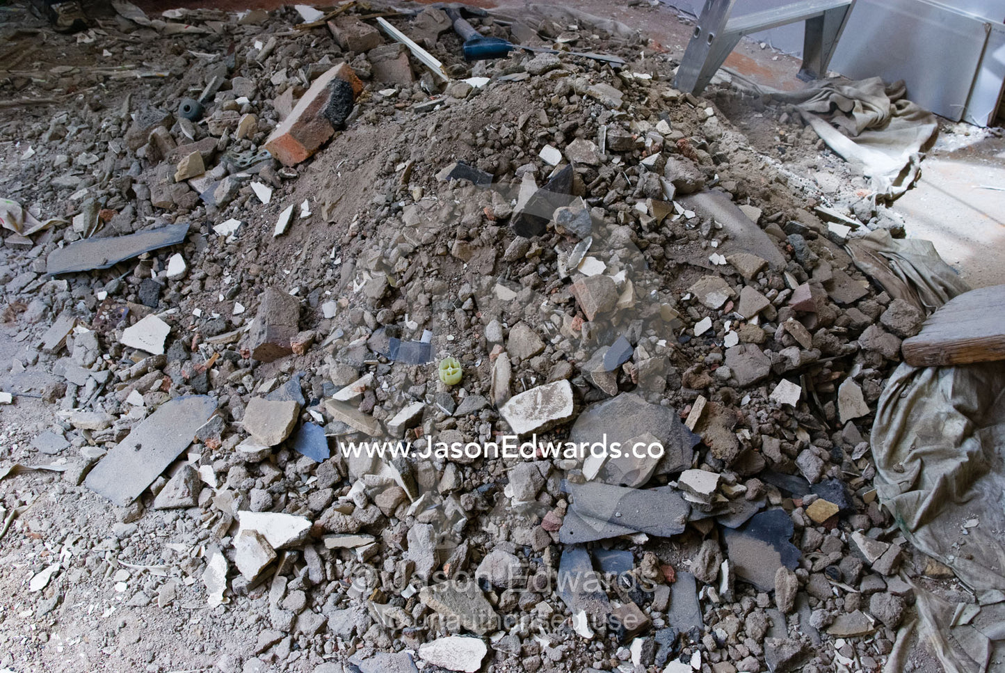 A mound of plaster, bricks and rubble in the living room of a house. Carlton North, Melbourne, Victoria, Australia.