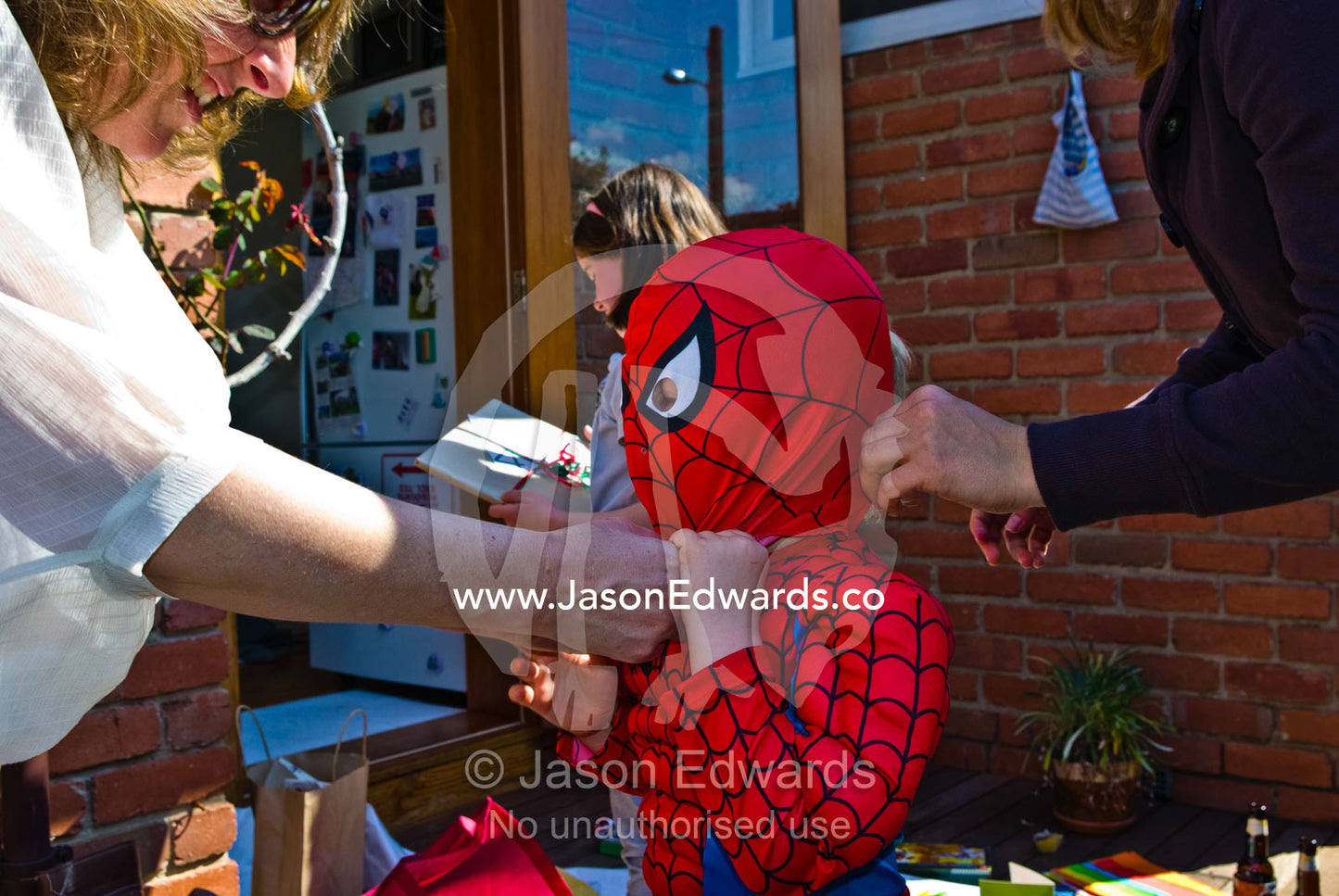 A boy plays dress-up in his new Spider Man outfit a birthday gift. Carlton North, Melbourne, Victoria, Australia.