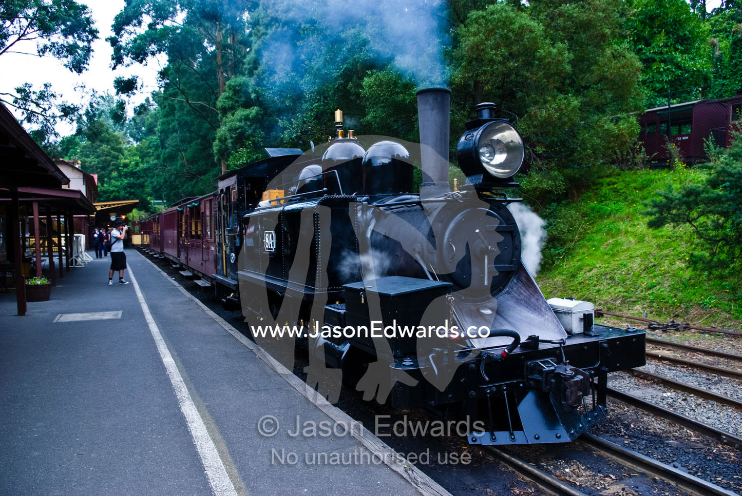An heritage steam train blowing smoke from its funnel at the station. Belgrave, Melbourne, Victoria, Australia.
