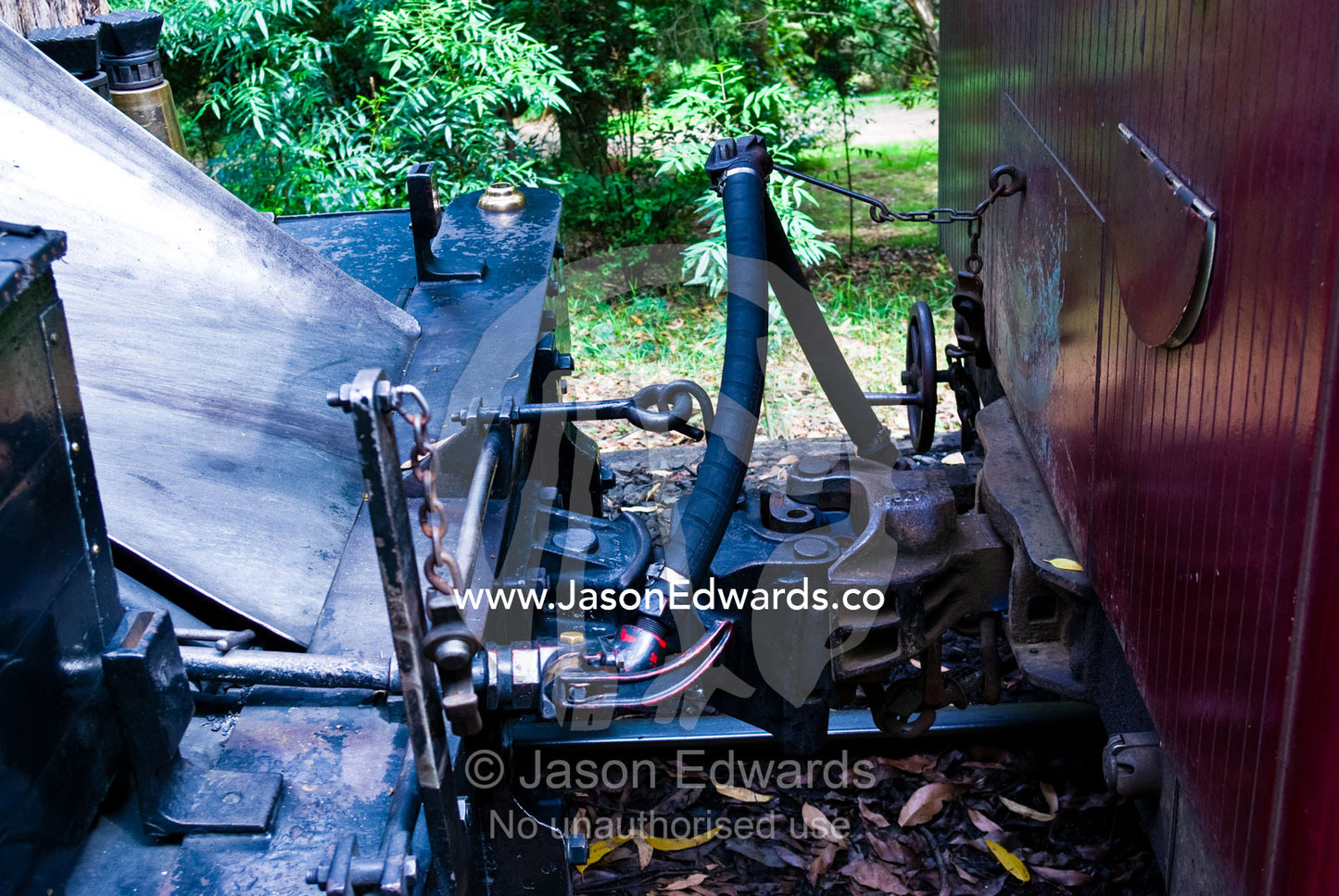An antique steam engine locomotive coupled to a passenger carriage. Lakeside, Emrald, Melbourne, Victoria, Australia.