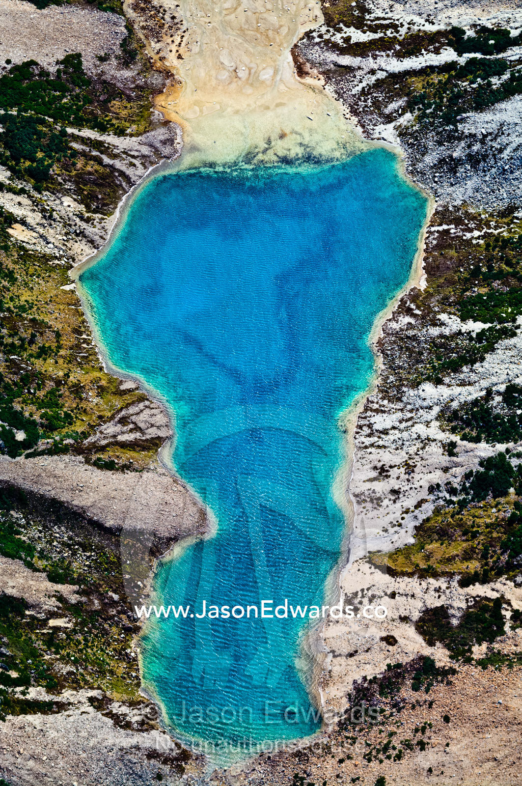 A lake fills with mineral-rich turquoise water from a glacier run-off. Ushuaia, Martial Mountains, Fuegian Andes, Ushuaia Bay, Tierra del Fuego Archipelago, Straits of Magellan, Tierra del Fuego Province, Patagonia, Argentina.
