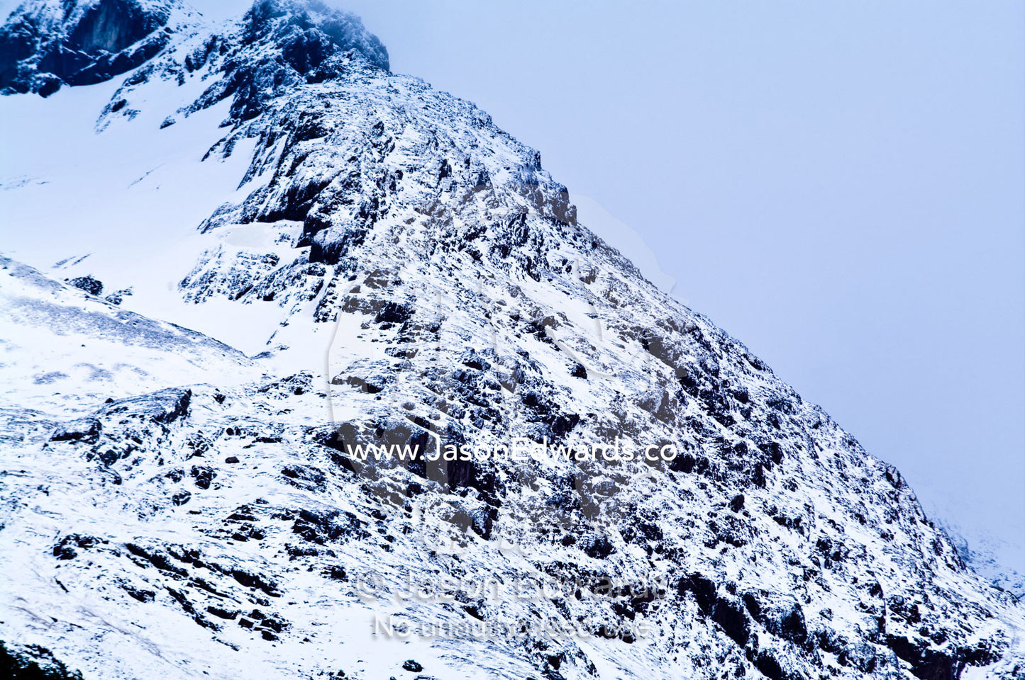 An inhospitable mountainside in a blizzard covered in snow and ice. Glacier El Martial, Ushuaia, Fuegian Andes, Tierra del Fuego Archipelago, Straits of Magellan, Tierra del Fuego Province, Patagonia, Argentina.