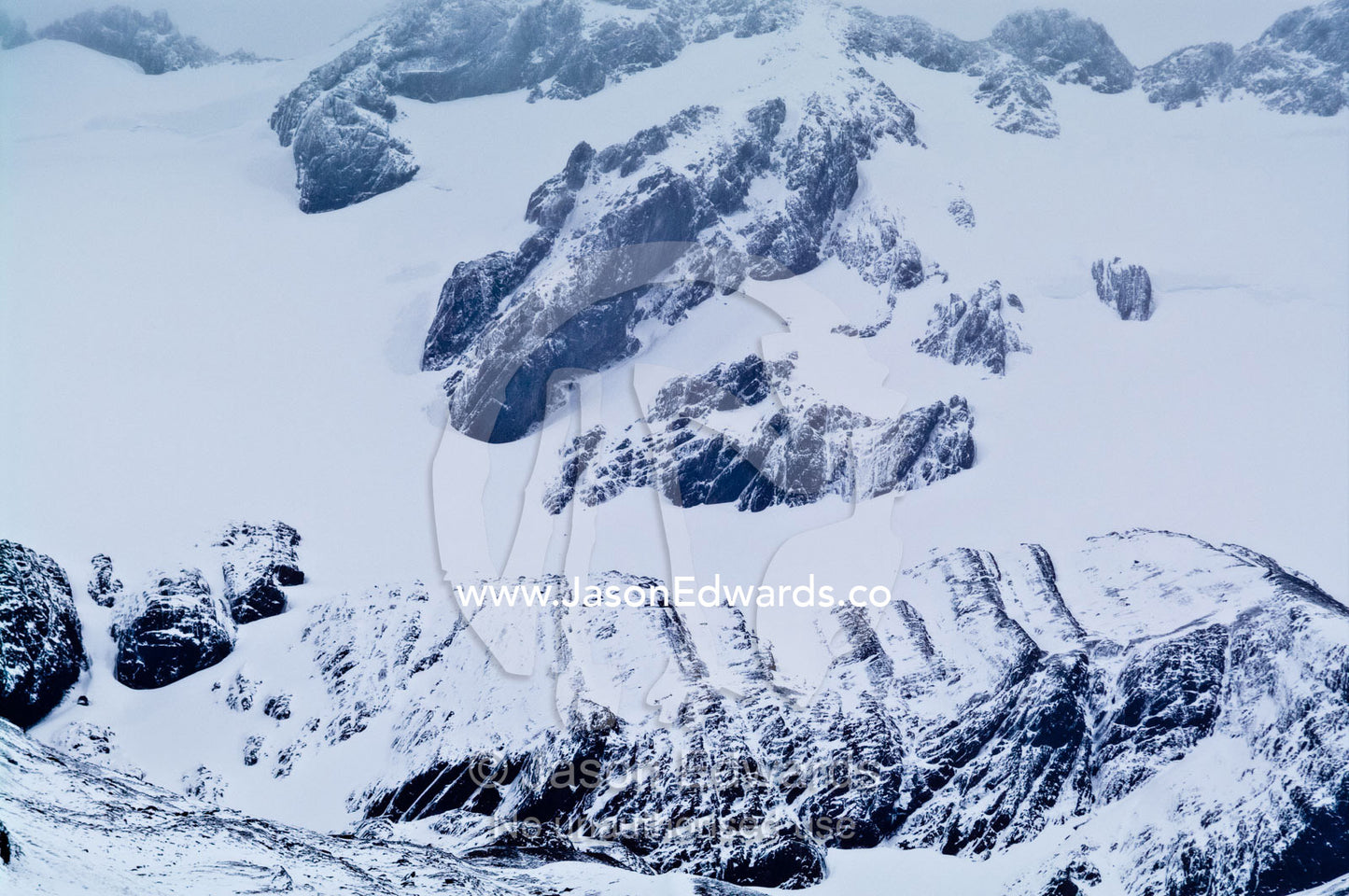 A inhospitable mountainside during a blizzard covered in snow and ice. Glacier El Martial, Ushuaia, Fuegian Andes, Tierra del Fuego Archipelago, Straits of Magellan, Tierra del Fuego Province, Patagonia, Argentina.