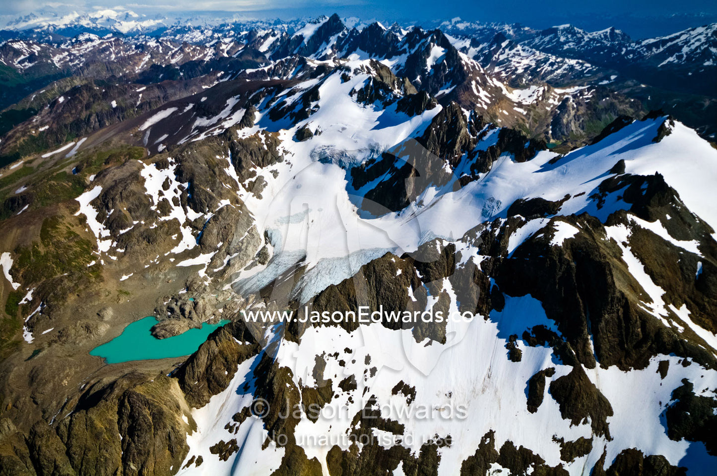 A remote turquoise glacial lake cradled by snow and ice draped peaks. Martial Mountains, Fuegian Andes, Tierra del Fuego Archipelago, Strait of Magellan, Tierra del Fuego Province, Patagonia, Argentina.