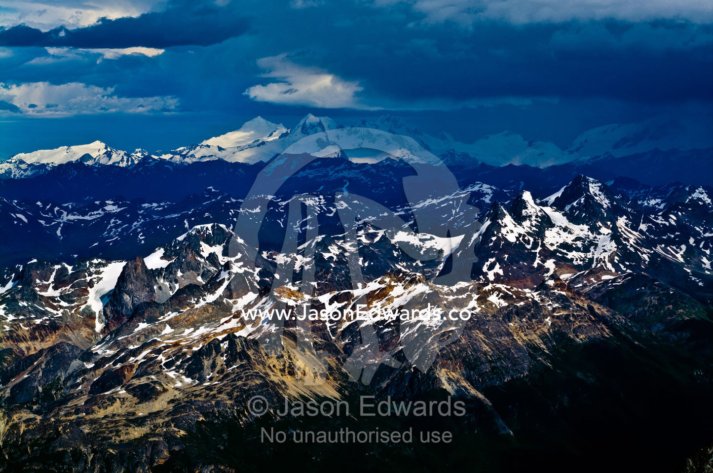 A winter storm engulfs the spine of the Andes covered in snow and ice. Ushuaia, Martial Mountains, Fuegian Andes, Tierra del Fuego Archipelago, Straits of Magellan, Tierra del Fuego Province, Patagonia, Argentina.