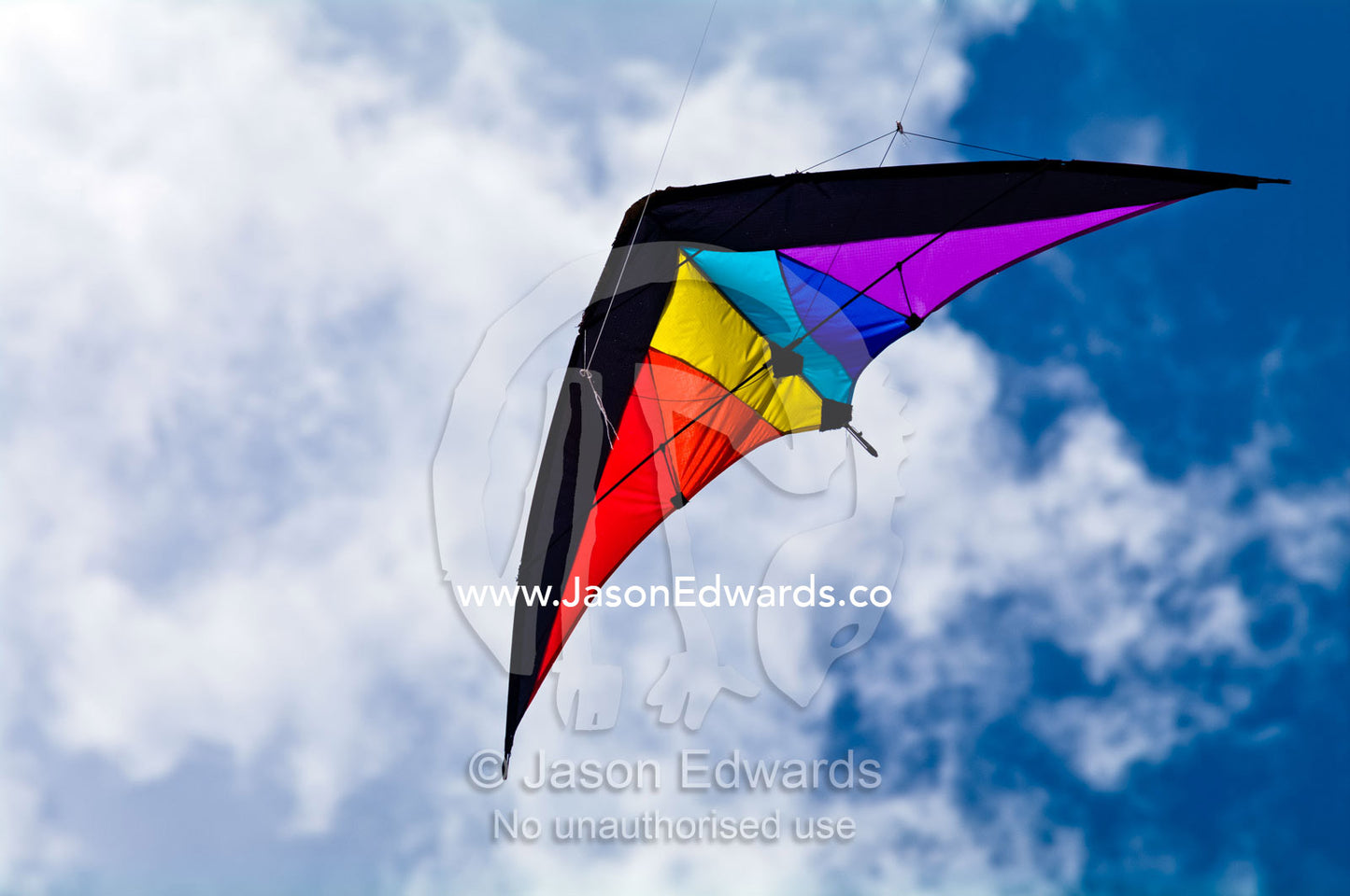 A delta-winged kite flashing primary colours in the summer sky. Venus Bay, Cape Liptrap Coastal Park, Bass Strait, South Gippsland, Victoria, Australia.