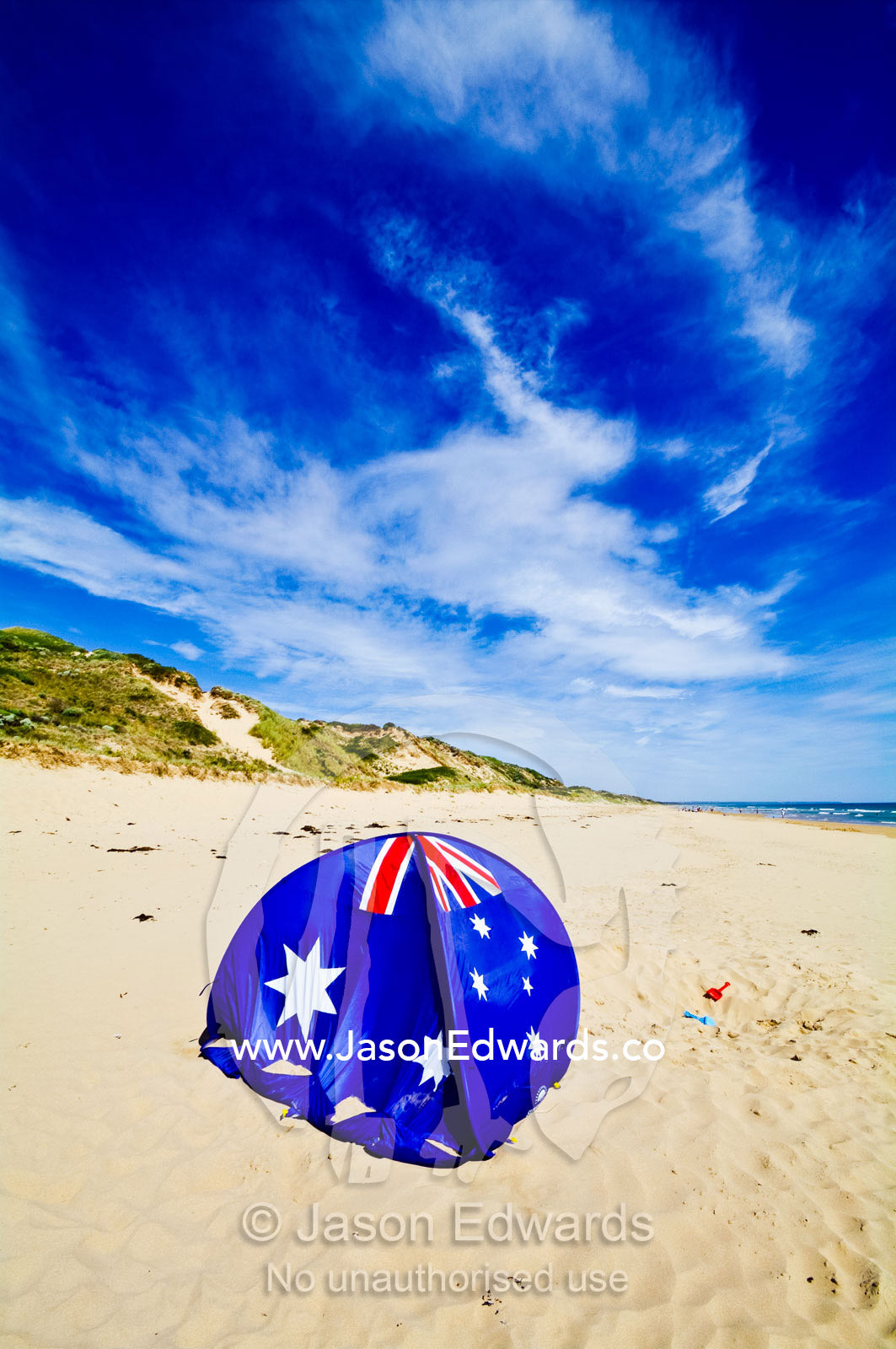 An Australian flag beach dome for shade on a sunny beach. Venus Bay, Cape Liptrap Coastal Park, Bass Strait, South Gippsland, Victoria, Australia.