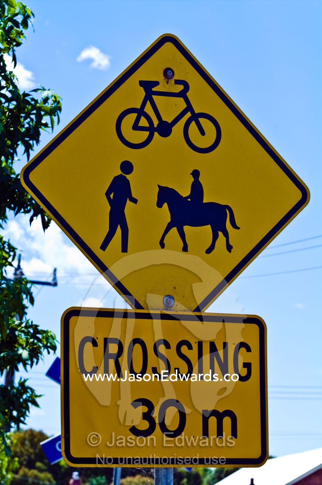A pedestrian crossing sign for people, horses and bicycles. Fish Creek, Gippsland, Victoria, Australia.