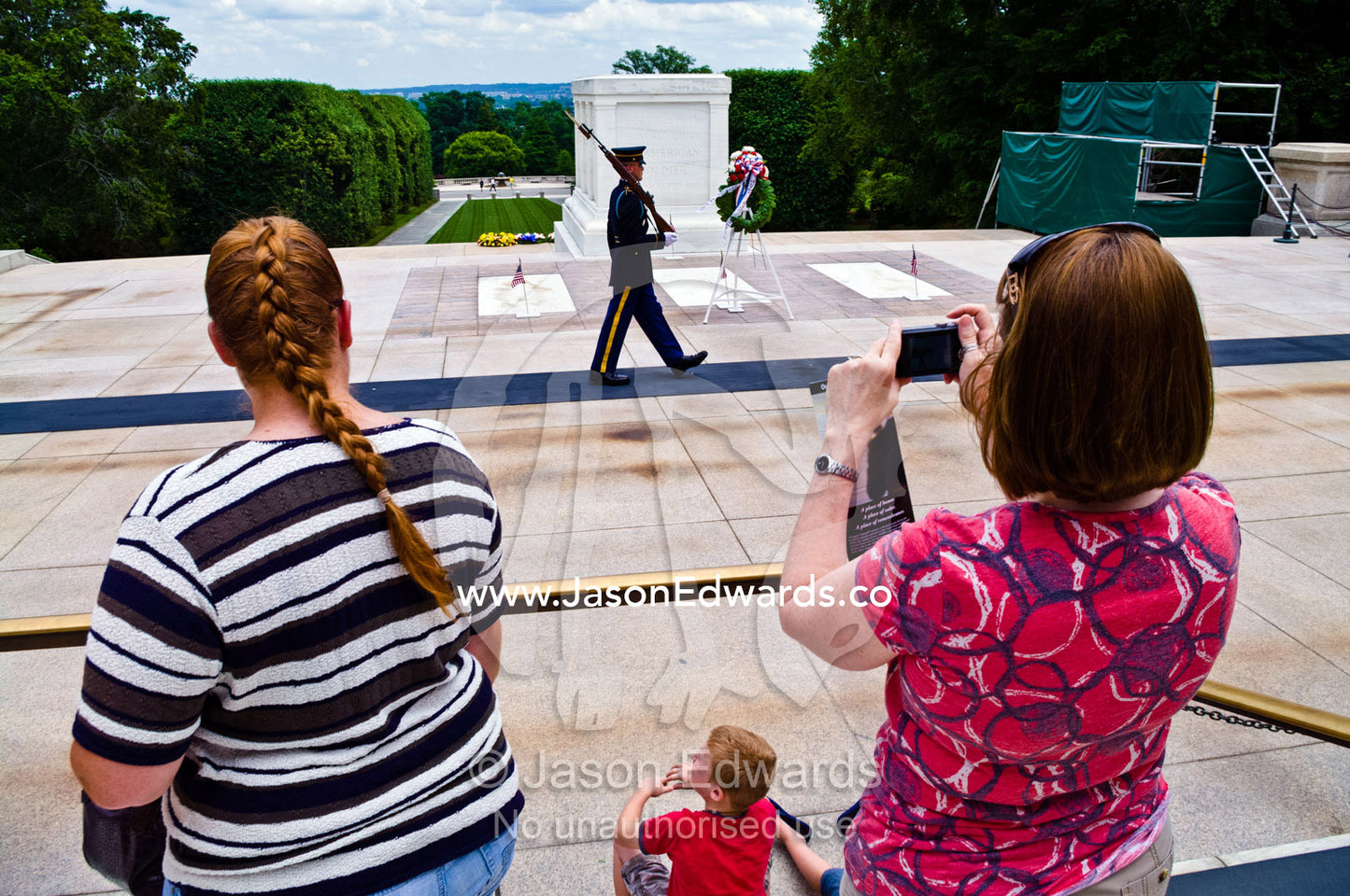 Memorial Day tourists photograph a guard at the Tomb of the Unknowns. Arlington National Cemetery, Arlington, Virginia, United States of America.