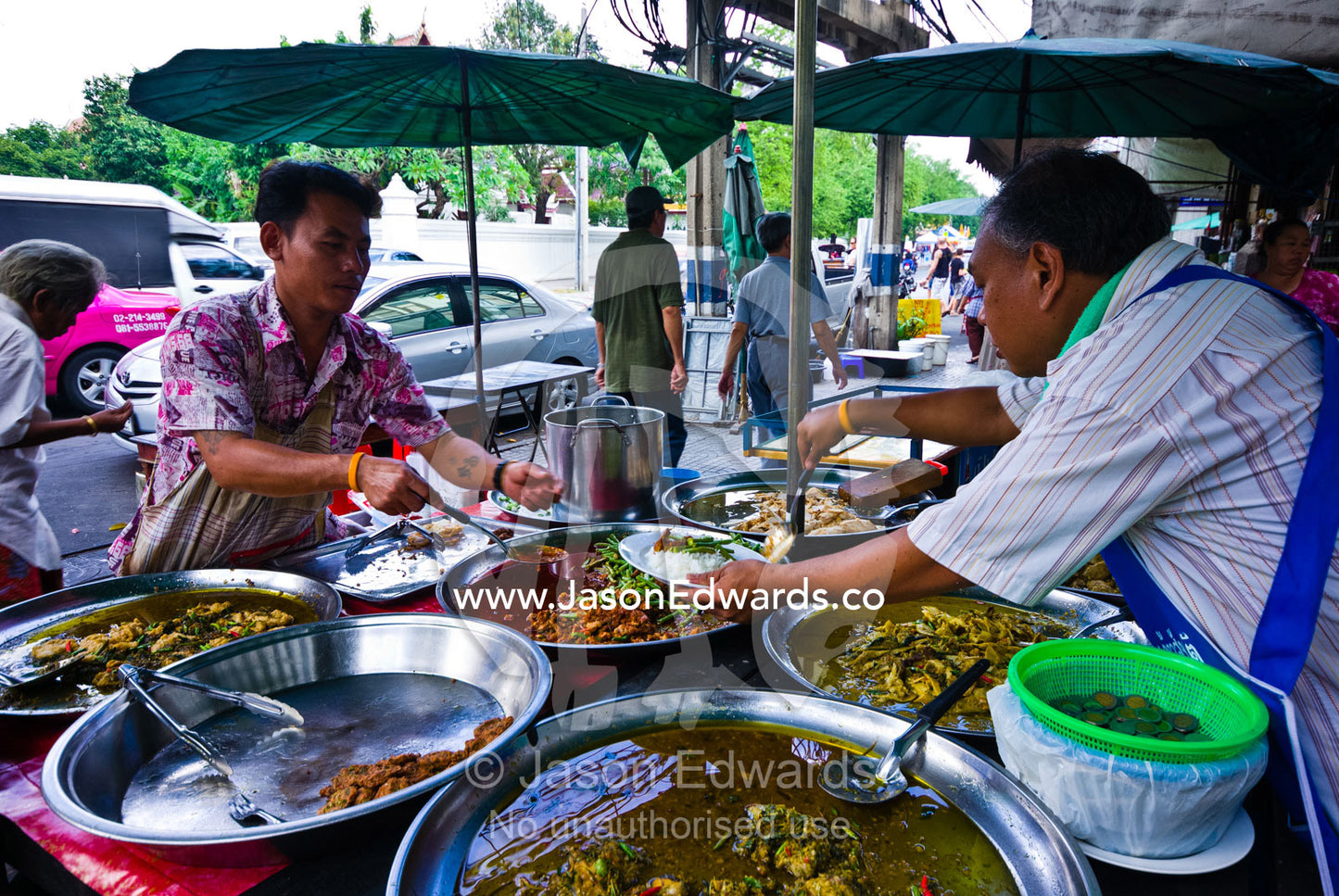 A stall owner serves a customer a lunch of rice and spicy beans. Phra Nakhon District, Rattanakosin District, Bangkok, Thailand.